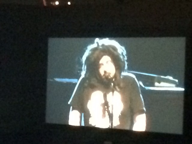 This is a photo of a tv screen in LA last weekend,  of Berkeley kid, Adam Duritz, the voice of my generation. But what's that thing alighted on his noggin?