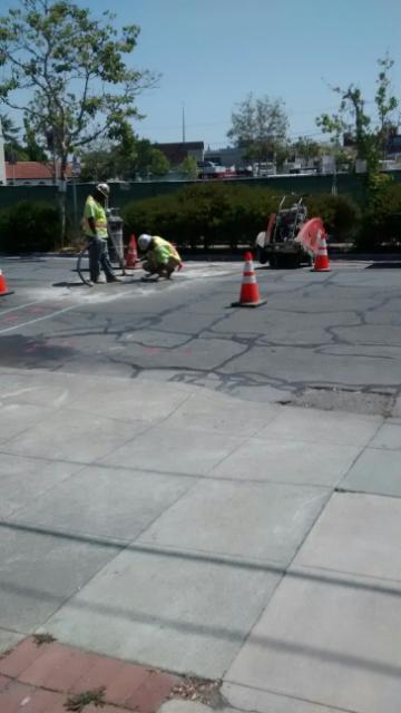 PREVAILING WAGERS: Earlier that day I had snapped this shot of two workers near the former JJ&F market in Palo Alto but am not sure if they are civic or private, union or scab; I know that they are 49er and Cowboy, if you check their head.