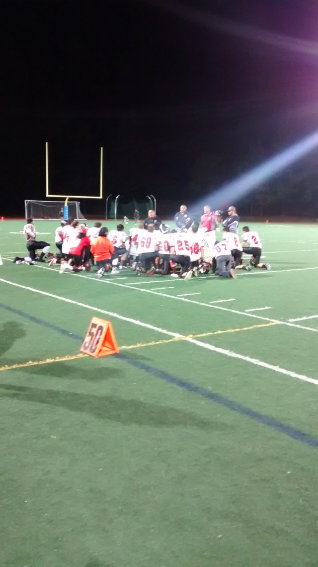 Gunn footballers also known as "14 Angry Men" console themselves after tough loss Friday